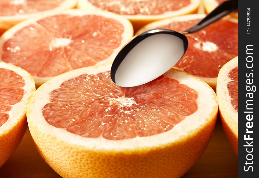 Couple of delishes grapefruits with a spoon. Couple of delishes grapefruits with a spoon