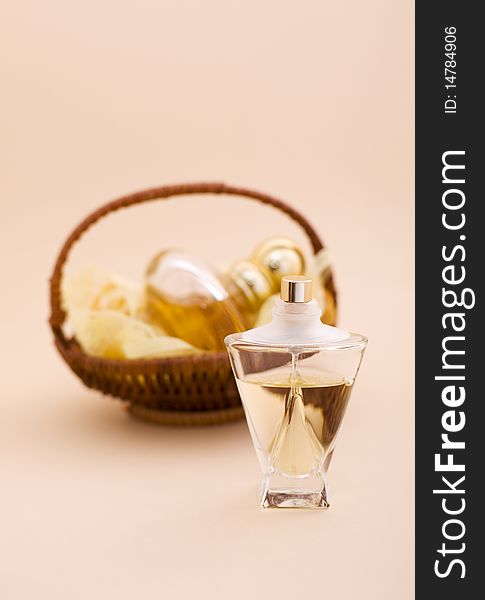 A glass bottle of perfume and fragrances in the basket