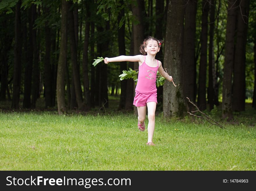 Little girl running in a park in summer. Little girl running in a park in summer.