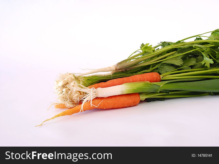 Fresh vegetables carrot, leek, celery, parsley on the white background. Fresh vegetables carrot, leek, celery, parsley on the white background