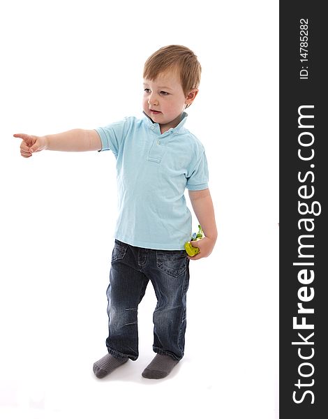 Boy pointing with toy in hand on white background. Boy pointing with toy in hand on white background
