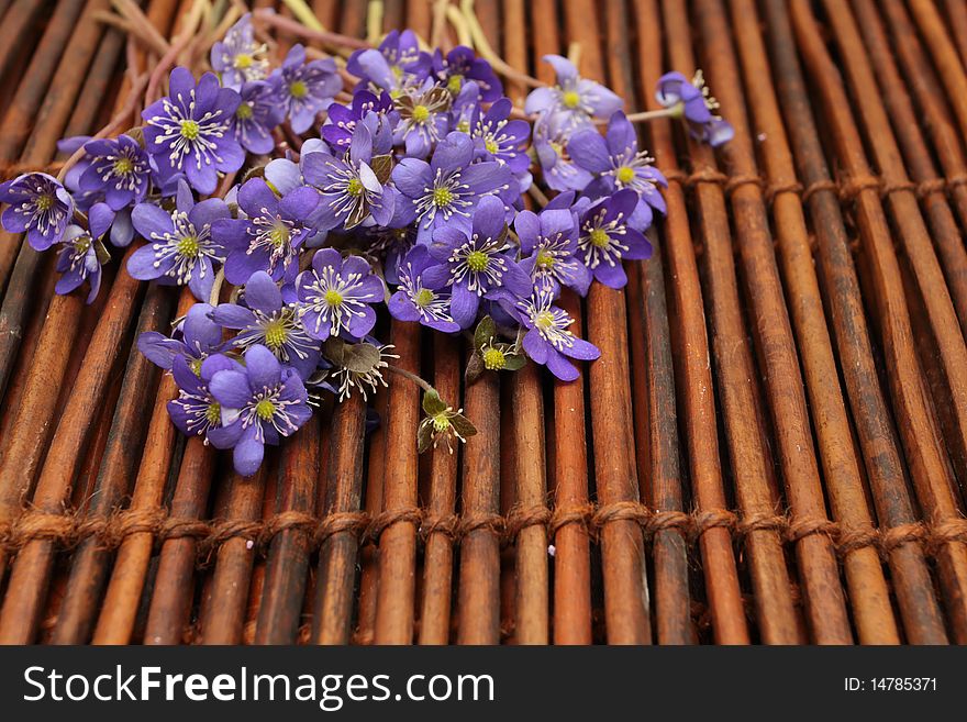 Violet Flowers On A Brown Mat