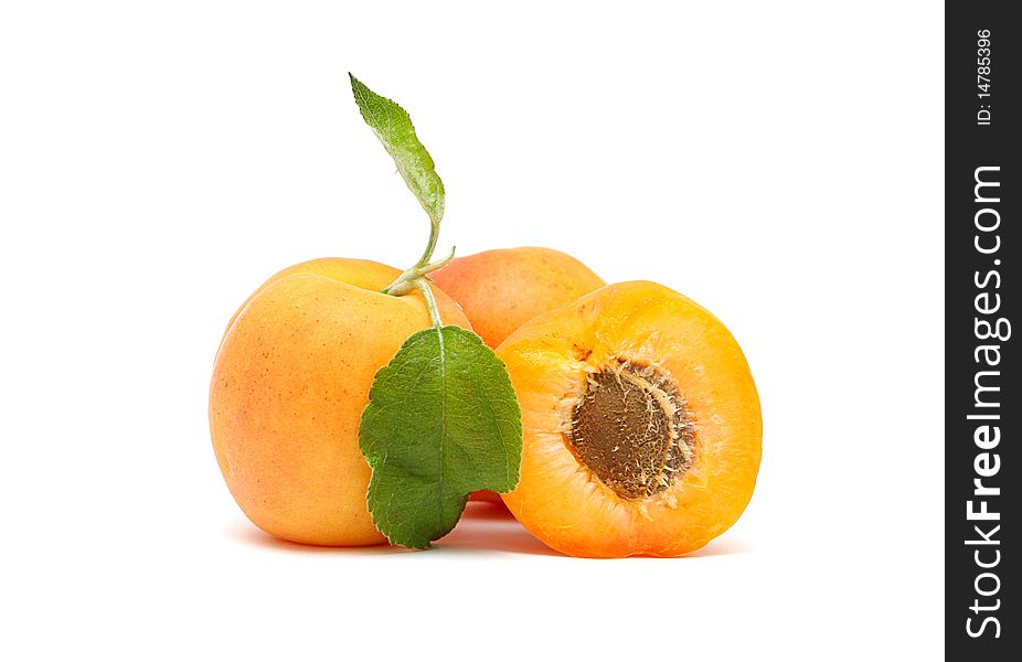 Apricots with leaves on a white background