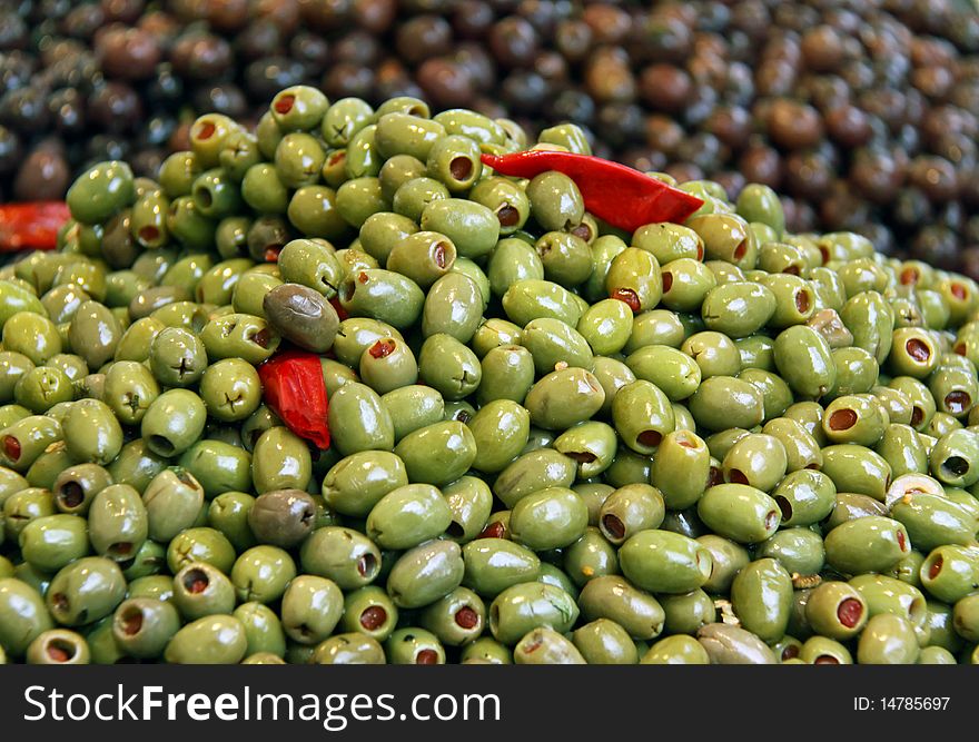 Green and black olives and sun dried tomatoes at a market