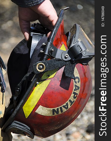A fire captain carries his helmet during a training exercise. A fire captain carries his helmet during a training exercise.