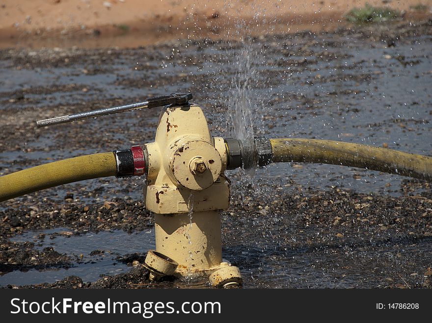 Water leaks from a hose connection during a fire training exercise. Water leaks from a hose connection during a fire training exercise.