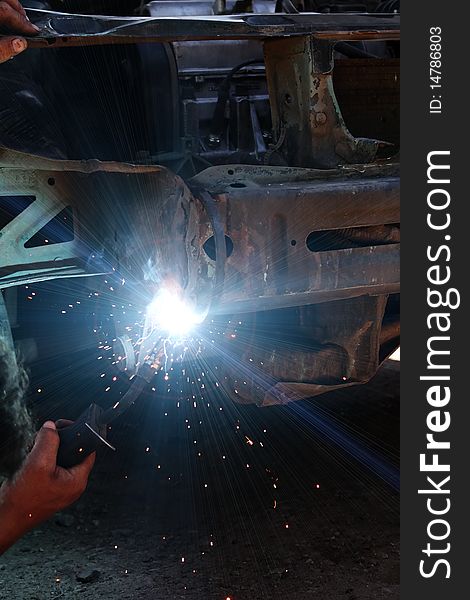 Welding metal smoke sparks in the course of repair the car. Welding metal smoke sparks in the course of repair the car