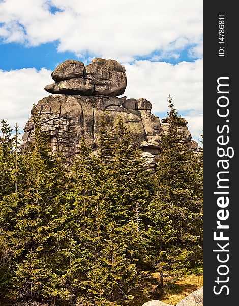 Spectacular rock over forest in mountains with blue sky and clouds. Spectacular rock over forest in mountains with blue sky and clouds.