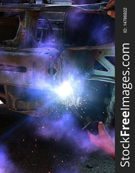 Welding metal smoke sparks in the course of repair the car. Welding metal smoke sparks in the course of repair the car