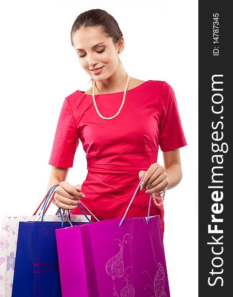 Young beautiful woman  in red dress with color packages. Young beautiful woman  in red dress with color packages