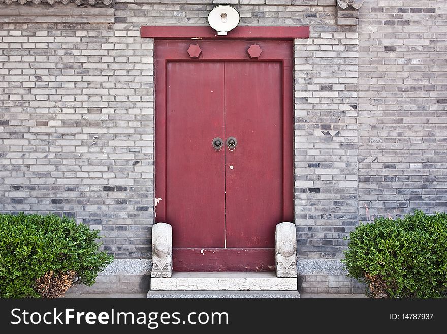 Red door in hutong area, close to Forbidden City, Beijing, China