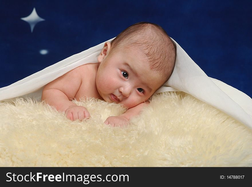 The indoor portrait of little Asian infant baby boy