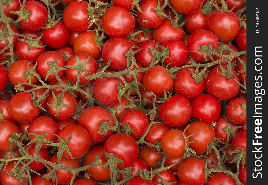 Organically grown red cherry tomatoes background