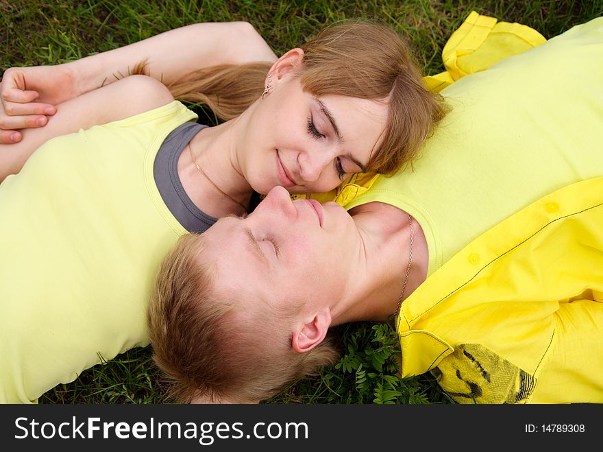 Young beautiful man and the woman lay on a grass. Young beautiful man and the woman lay on a grass