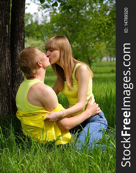 Young guy and the girl kiss in park. Young guy and the girl kiss in park