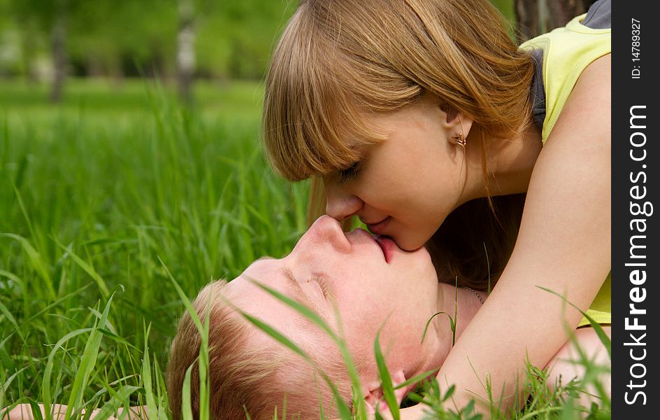 Young beautiful woman and the man lay on a grass. Young beautiful woman and the man lay on a grass