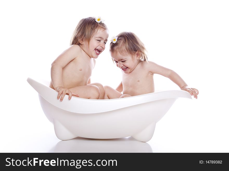 Children in white bath tub on white background