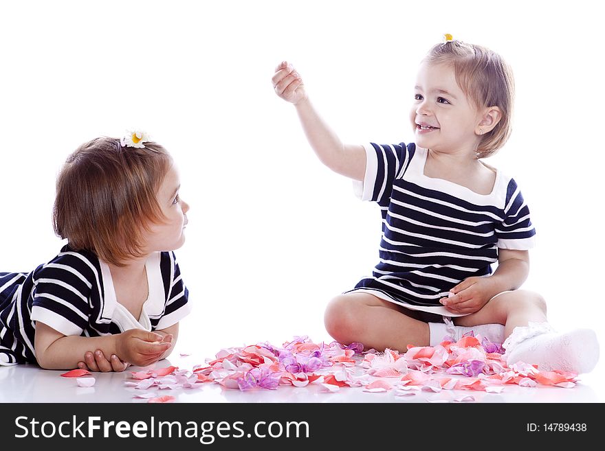 Small children play with toys on white background