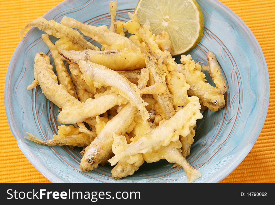 Delicious fresh fried fish on plate with lemon. Delicious fresh fried fish on plate with lemon