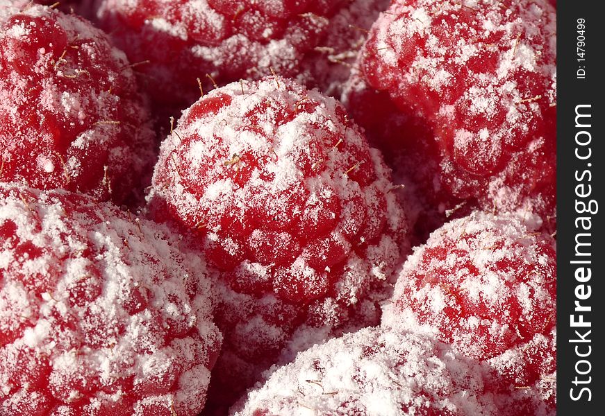 A macro shot of a heap of sweet raspberries