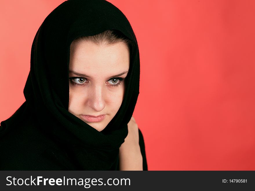 Girl in black clothes on the red background. Girl in black clothes on the red background