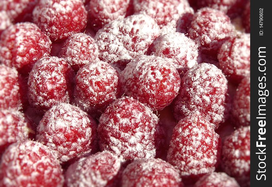 A macro shot of a heap of sweet raspberries