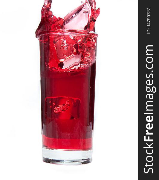 Ice cube splashes into ice cold cranberry juice. Ice cube splashes into ice cold cranberry juice