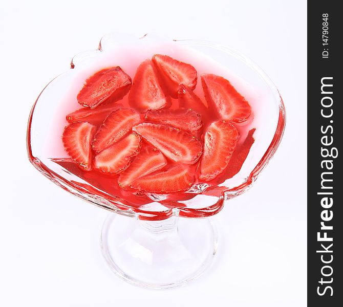 Jelly with strawberries in a glass cup