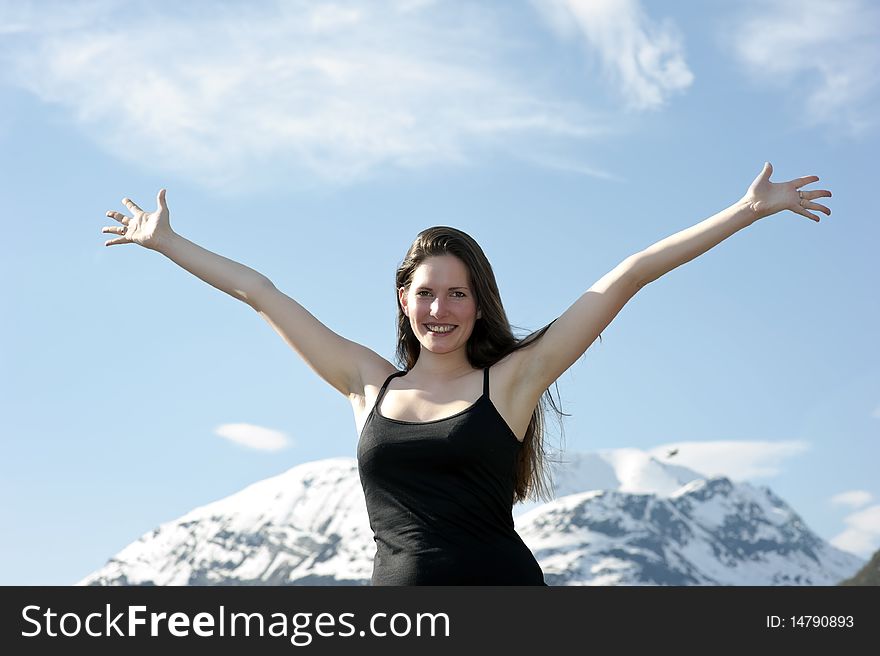 Woman hiker raising up her arms in the air on a mountain after. Woman hiker raising up her arms in the air on a mountain after