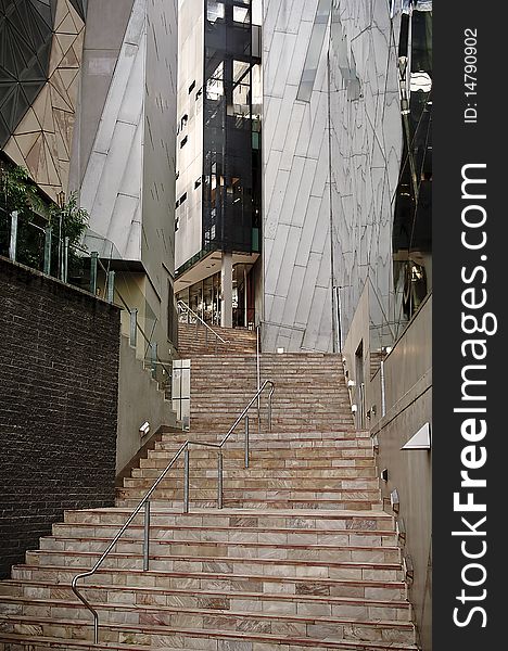 Steps in a city leading between modern buildings. Steps in a city leading between modern buildings