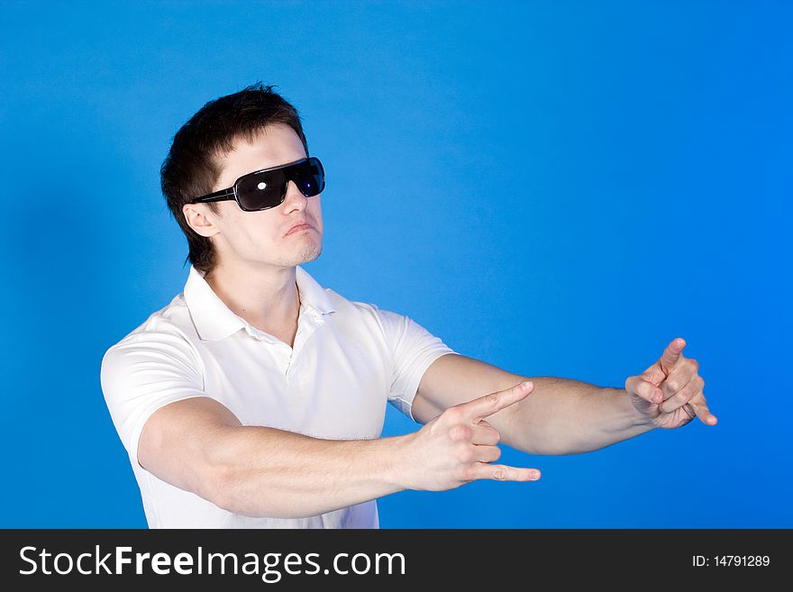 Brave Guy In The Studio Against A Blue Background