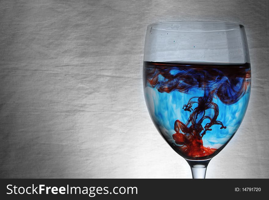 Blue And Red Liquid In Wineglass