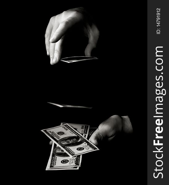 Hand with packs of dollars over black. Hand with packs of dollars over black