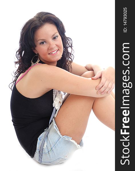 Photograph showing pretty young girl sitting isolated against white. Photograph showing pretty young girl sitting isolated against white