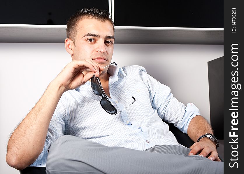 Young man with sunglasses sitting