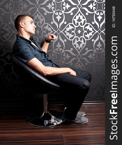 Cool guy sitting on an armchair