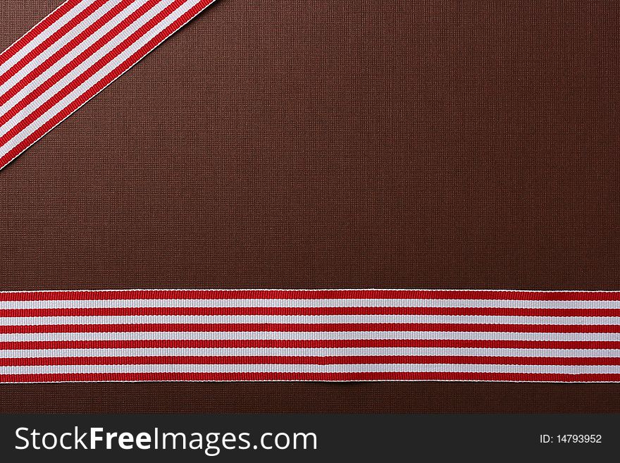 Brown background with two red-white tapes for design works.