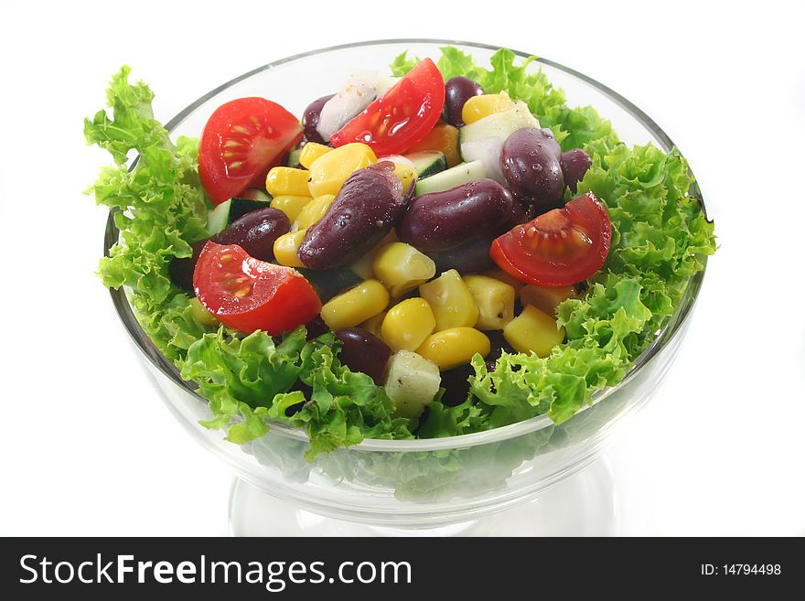 Mixed salad in a bowl on a white background. Mixed salad in a bowl on a white background