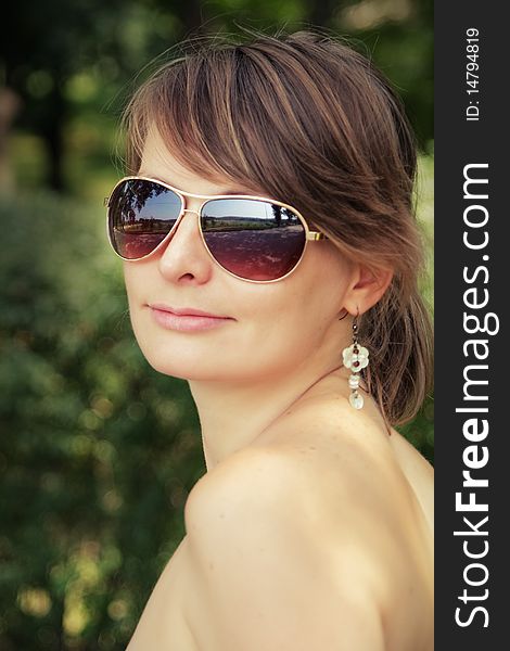 Young woman outside wearing sunglasses