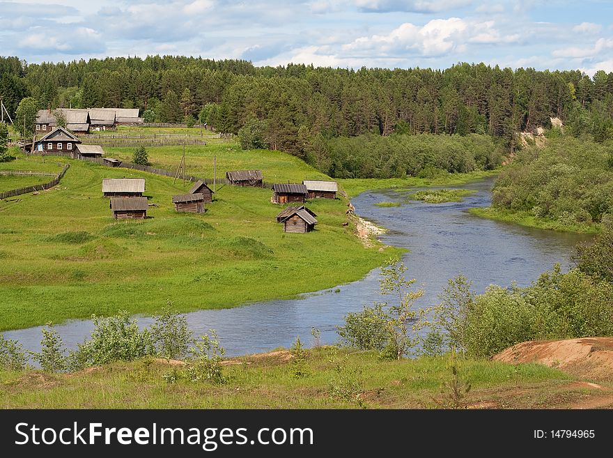 The old village in the forest with the river in the Russian north. The old village in the forest with the river in the Russian north