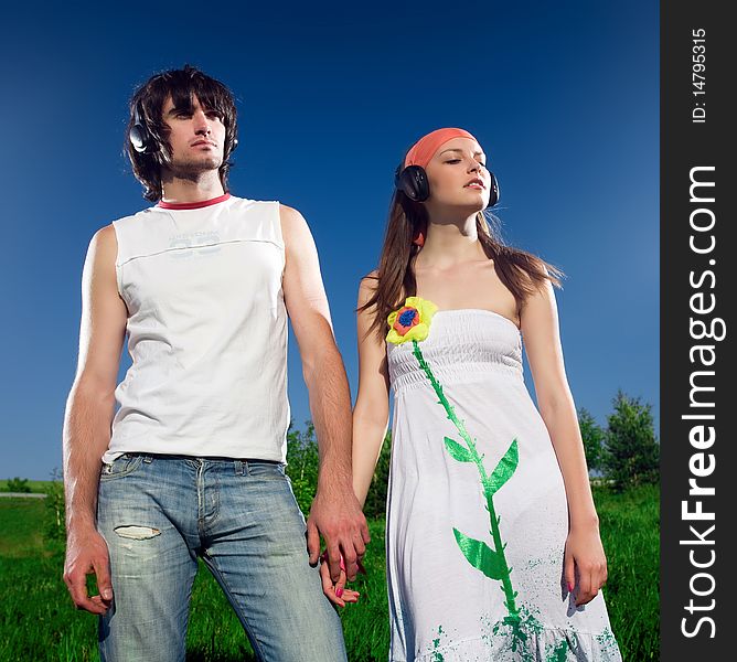 Boy with long-haired girl in headphones. Boy with long-haired girl in headphones