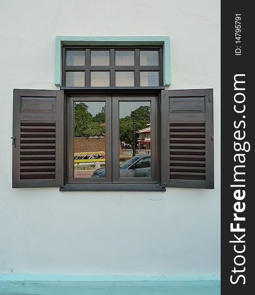 A brown wooden window with reflection. A brown wooden window with reflection