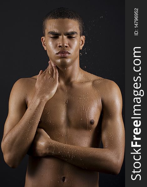 Drops of the water on naked body of a young man on black background. Drops of the water on naked body of a young man on black background.