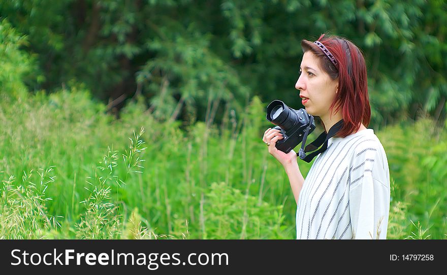 Portrait of a beautiful young girl who enjoys photographing in nature.