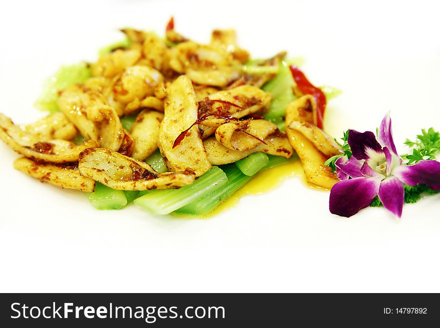 Chinese food on the table.Cooked squid with celery.