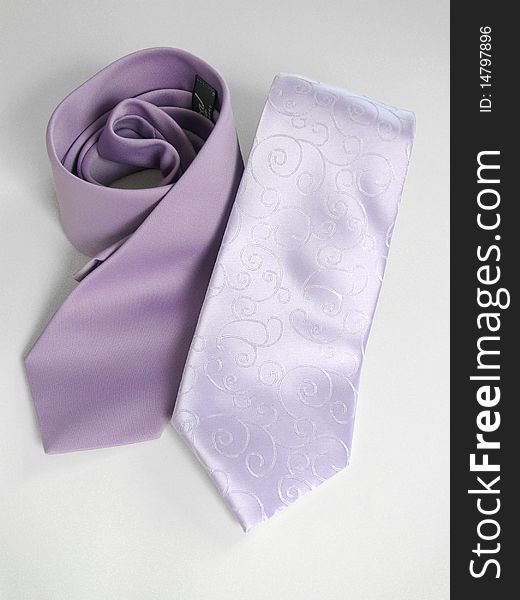 Two lila tie on gray background