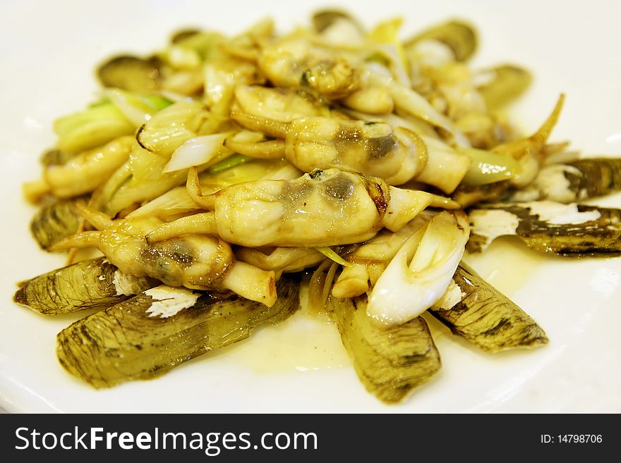 Cooked razor clams on the plate. Chinese-style seafood's cooking.