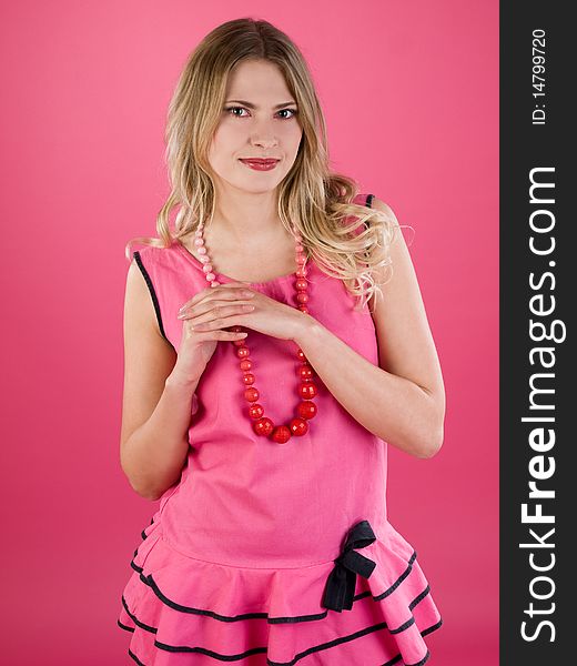 Portrait of beautiful smiley woman in pink dress