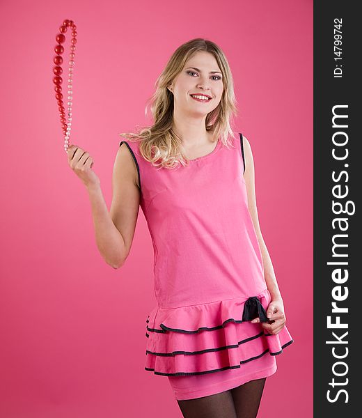 Portrait of beautiful smiley woman in pink dress