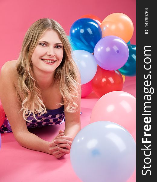 Pretty woman with colorful balloons on pink background. Pretty woman with colorful balloons on pink background